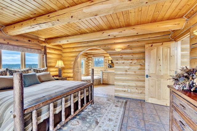 1130 Hegson Dr, Stevensville, MT 59870 - bedroom featuring rustic walls, wooden ceiling with exposed beams, and arched walkways
