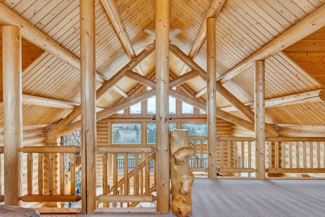 1130 Hegson Dr, Stevensville, MT 59870 - detailed view of log walls, wood ceiling with exposed beams, and carpet floors