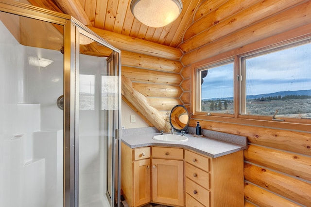 1130 Hegson Dr, Stevensville, MT 59870 - kitchen featuring log walls, a sink, and light brown cabinetry
