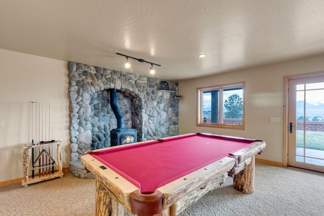 1130 Hegson Dr, Stevensville, MT 59870 - rec room featuring carpet floors, baseboards, track lighting, a wood stove, and billiards table