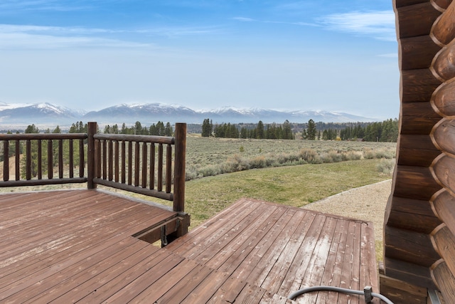 1130 Hegson Dr, Stevensville, MT 59870 - wooden deck featuring a mountain view and a lawn