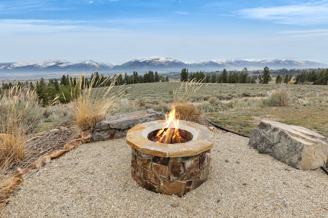 1130 Hegson Dr, Stevensville, MT 59870 - view of patio featuring an outdoor fire pit and a mountain view