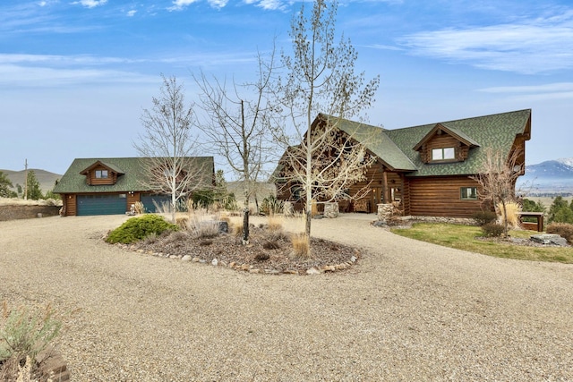 1130 Hegson Dr, Stevensville, MT 59870 - log cabin with dirt driveway, log exterior, and an attached garage