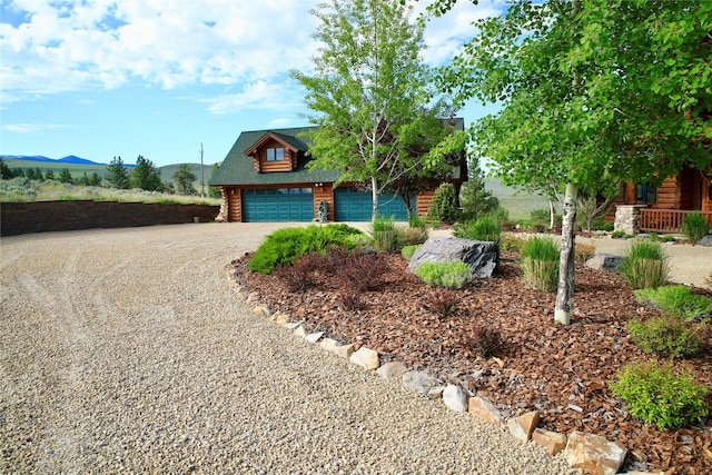 1130 Hegson Dr, Stevensville, MT 59870 - log cabin with log exterior, a mountain view, and driveway