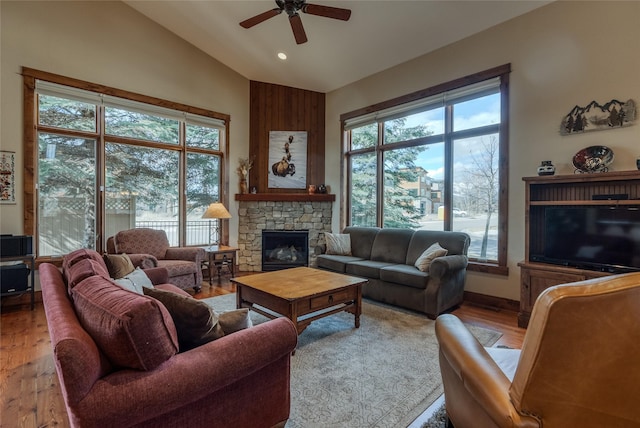 1 Rock Creek Ct, Whitefish, MT 59937 - living room with ceiling fan, wood finished floors, a stone fireplace, high vaulted ceiling, and recessed lighting