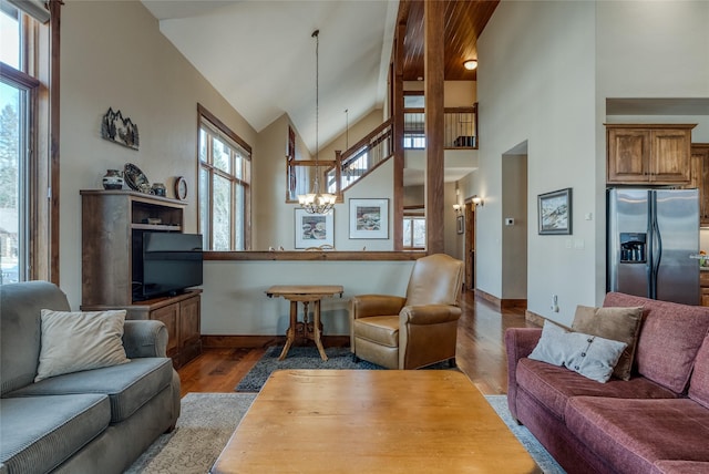 1 Rock Creek Ct, Whitefish, MT 59937 - living room featuring wood finished floors, high vaulted ceiling, a chandelier, and baseboards
