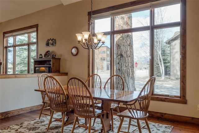 1 Rock Creek Ct, Whitefish, MT 59937 - dining area featuring wood finished floors, plenty of natural light, a chandelier, and baseboards