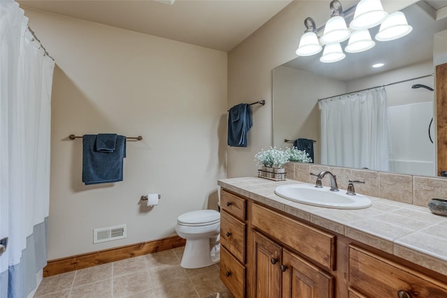 1 Rock Creek Ct, Whitefish, MT 59937 - full bath featuring baseboards, toilet, vanity, tile patterned floors, and a chandelier