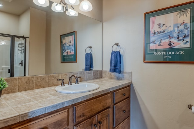 1 Rock Creek Ct, Whitefish, MT 59937 - bathroom featuring a stall shower, vanity, and a chandelier