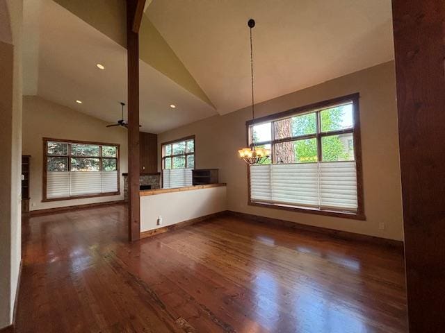 1 Rock Creek Ct, Whitefish, MT 59937 - unfurnished dining area with lofted ceiling, dark wood-style flooring, a ceiling fan, a chandelier, and recessed lighting