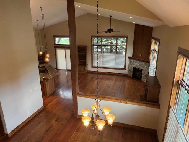 1 Rock Creek Ct, Whitefish, MT 59937 - kitchen with wood finished floors, a fireplace, high vaulted ceiling, ceiling fan, and recessed lighting