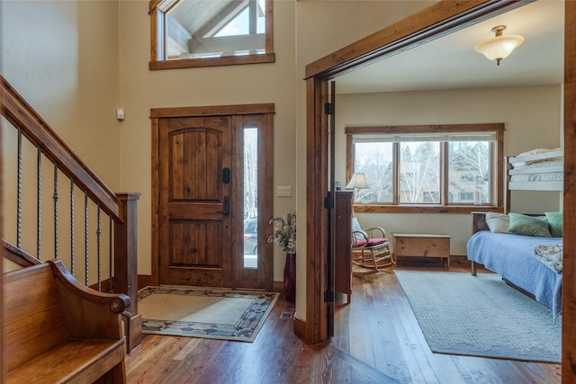 1 Rock Creek Ct, Whitefish, MT 59937 - foyer entrance with wood finished floors, stairway, a towering ceiling, and baseboards