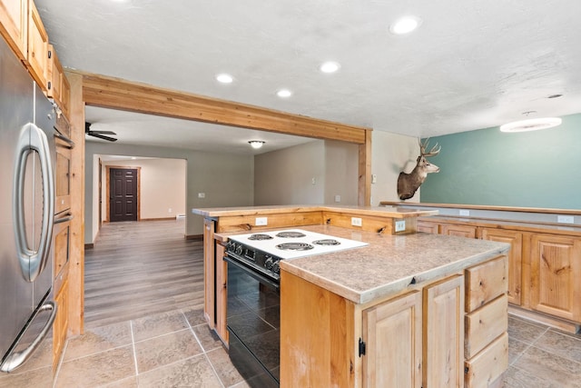 253 Aero Ln, Bigfork, MT 59911 - kitchen featuring appliances with stainless steel finishes, light brown cabinets, light countertops, recessed lighting, and a kitchen island