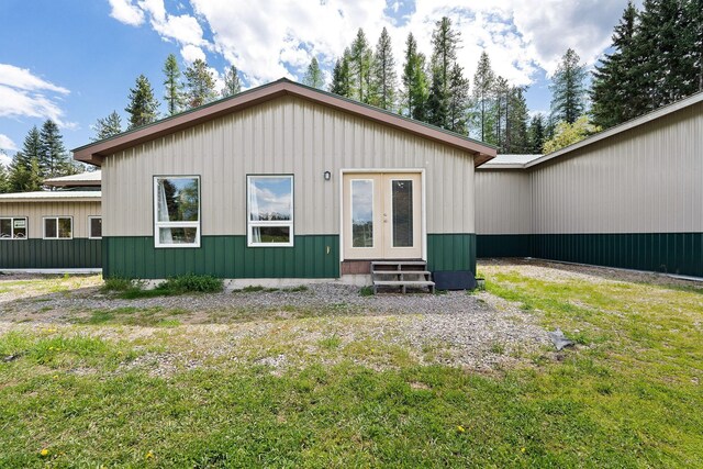 253 Aero Ln, Bigfork, MT 59911 - rear view of house with entry steps and a lawn