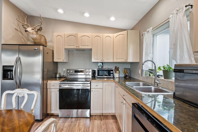 253 Aero Ln, Bigfork, MT 59911 - kitchen featuring stainless steel appliances, lofted ceiling, light wood-style floors, recessed lighting, and tile counters