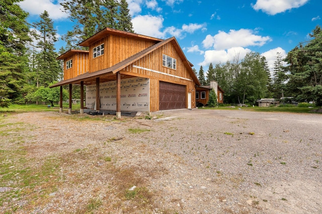253 Aero Ln, Bigfork, MT 59911 - view of side of home featuring a garage and driveway
