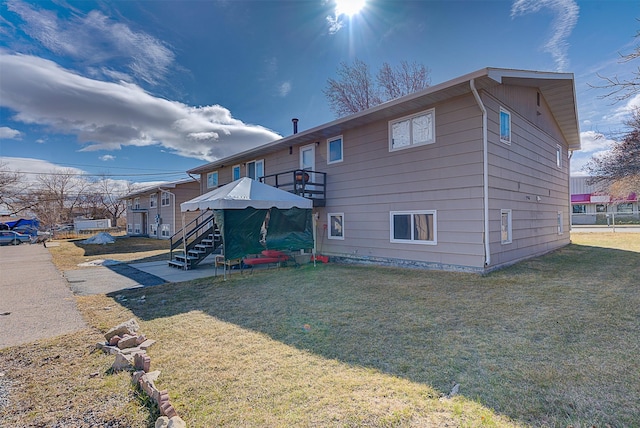 1312 Cole Ave, Helena, MT 59601 - rear view of house featuring stairway and a lawn