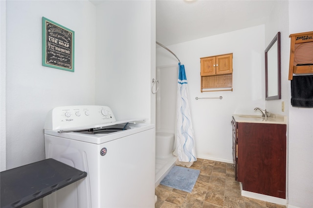 433 Swamp Creek Rd, Wise River, MT 59762 - washroom with baseboards, washer / clothes dryer, a sink, stone finish flooring, and laundry area
