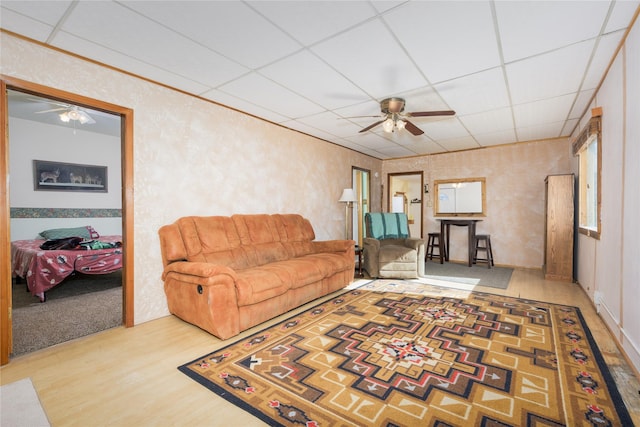 433 Swamp Creek Rd, Wise River, MT 59762 - living room featuring wood finished floors, a paneled ceiling, and a ceiling fan