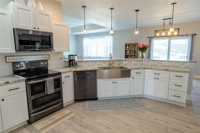 9 Ridge View Cir, Montana City, MT 59634 - kitchen featuring stainless steel appliances, light wood-style flooring, white cabinetry, a peninsula, and light stone counters