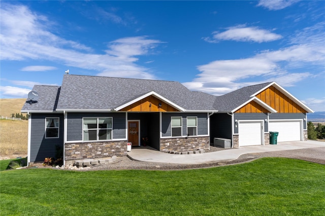9 Ridge View Cir, Montana City, MT 59634 - craftsman inspired home with stone siding, board and batten siding, an attached garage, a front yard, and roof with shingles