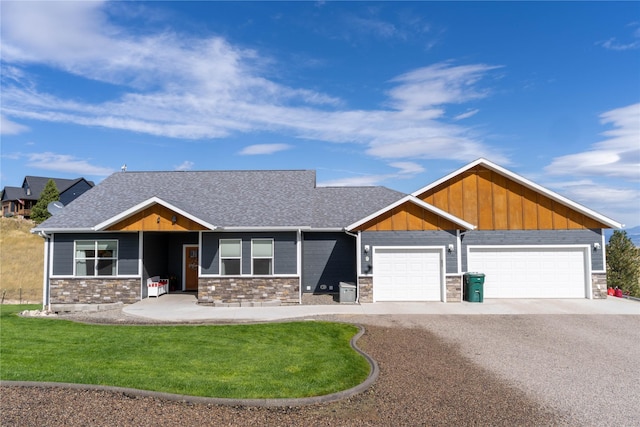 9 Ridge View Cir, Montana City, MT 59634 - craftsman inspired home featuring gravel driveway, stone siding, an attached garage, board and batten siding, and a front yard