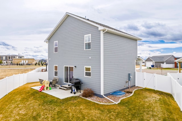 2009 Meriwether Ct, Great Falls, MT 59405 - back of property with a fenced backyard, a gate, a patio, and a yard