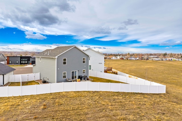2009 Meriwether Ct, Great Falls, MT 59405 - rear view of house featuring cooling unit, a fenced backyard, a yard, and a residential view