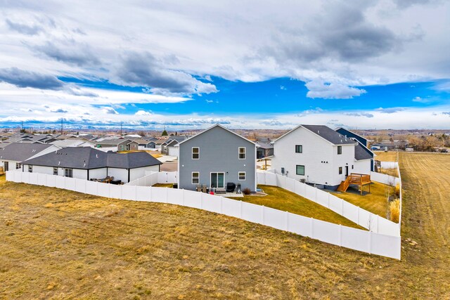 2009 Meriwether Ct, Great Falls, MT 59405 - rear view of house featuring a fenced backyard, a residential view, and a lawn