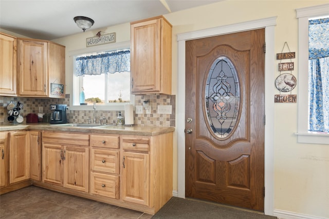 552 Pat Ln, Stevensville, MT 59870 - kitchen featuring light countertops, a sink, light brown cabinetry, and decorative backsplash