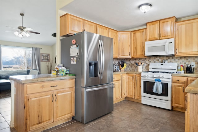 552 Pat Ln, Stevensville, MT 59870 - kitchen featuring light brown cabinets, tasteful backsplash, ceiling fan, and white appliances