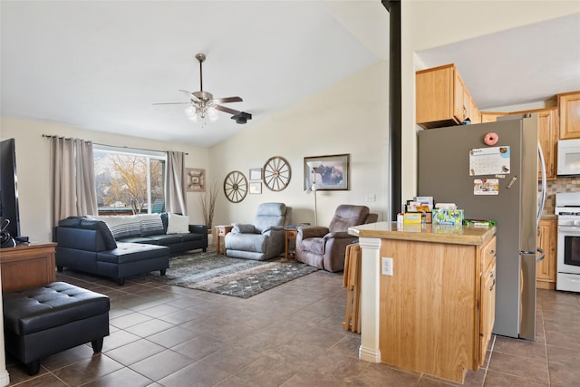 552 Pat Ln, Stevensville, MT 59870 - living room featuring a ceiling fan, dark tile patterned flooring, and vaulted ceiling