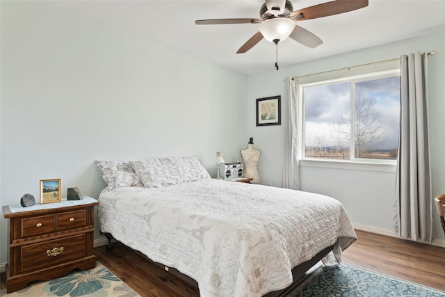 552 Pat Ln, Stevensville, MT 59870 - bedroom with baseboards, wood finished floors, and a ceiling fan