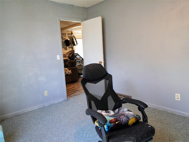sitting room featuring carpet and baseboards