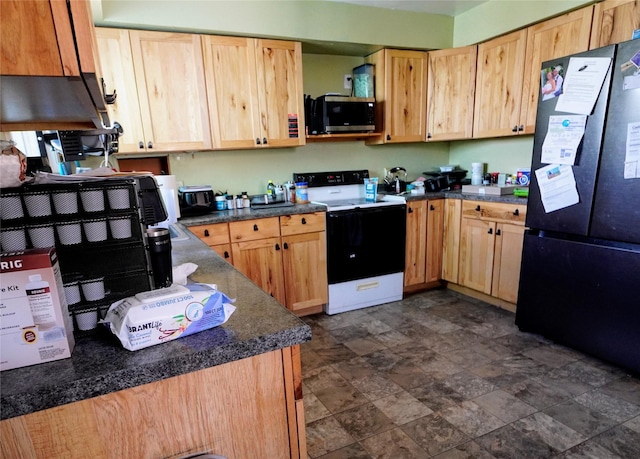 kitchen featuring freestanding refrigerator, stainless steel microwave, light brown cabinets, and electric range