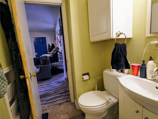 bathroom with toilet and vanity