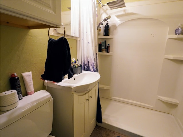 full bathroom with toilet, a shower, and vanity