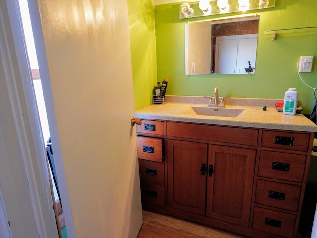 bathroom featuring wood finished floors and vanity