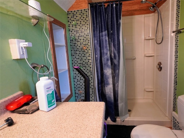 bathroom featuring a stall shower and toilet