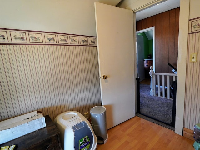 bathroom featuring wooden walls and wood finished floors