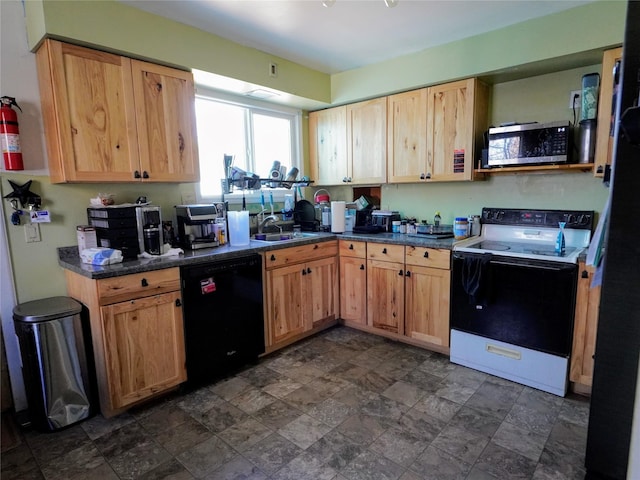kitchen featuring dishwasher, stainless steel microwave, dark countertops, electric stove, and a sink