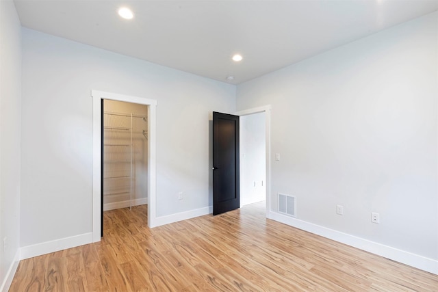 2212 S 12th St W, Missoula, MT 59801 - unfurnished bedroom featuring light wood-style flooring, visible vents, baseboards, recessed lighting, and a spacious closet