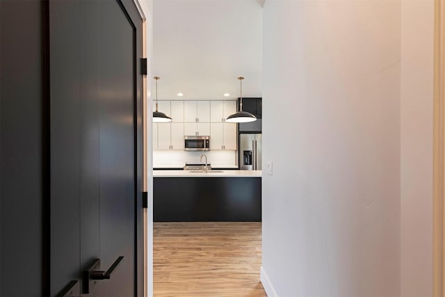 2212 S 12th St W, Missoula, MT 59801 - hall with baseboards, a sink, recessed lighting, and light wood-type flooring