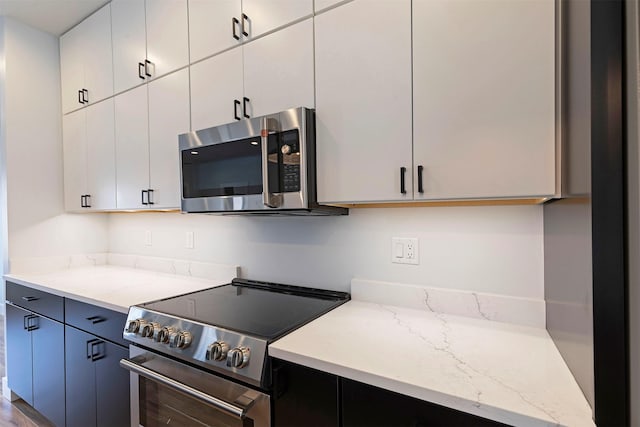 2212 S 12th St W, Missoula, MT 59801 - kitchen featuring white cabinetry, stainless steel appliances, and light stone counters