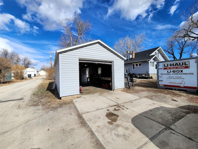 detached garage with concrete driveway