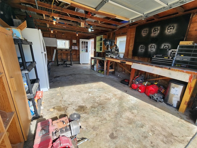 garage with a workshop area and a garage door opener