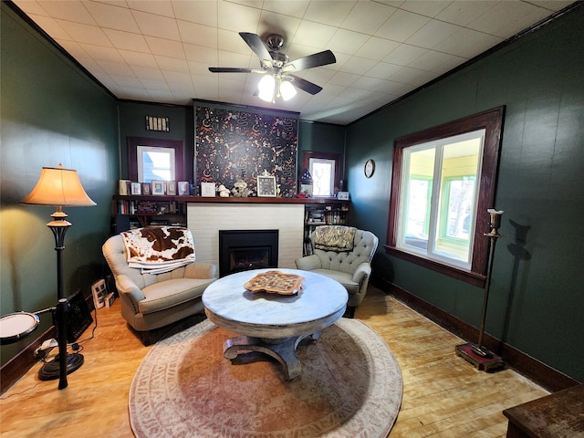 living room with plenty of natural light, a fireplace, and wood finished floors