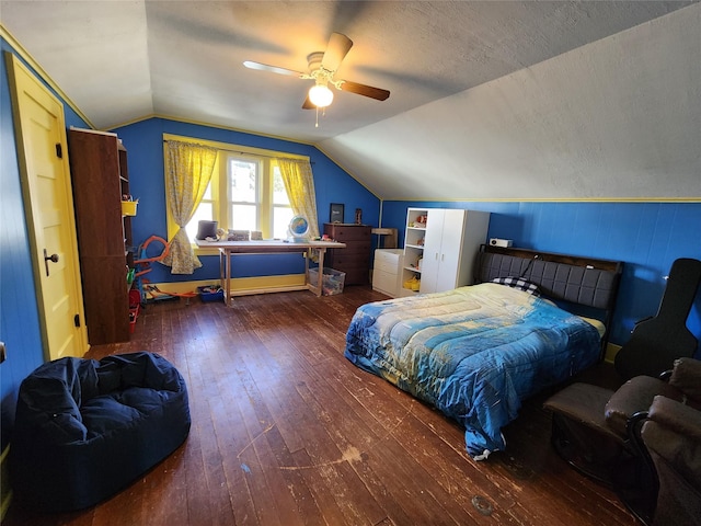 bedroom featuring lofted ceiling, a ceiling fan, hardwood / wood-style flooring, and a textured ceiling