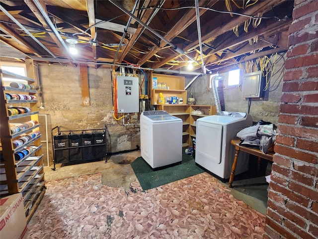 below grade area featuring washing machine and clothes dryer and electric panel