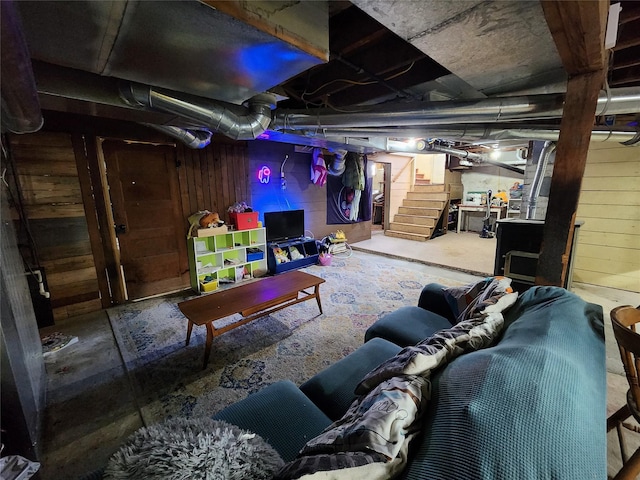 unfinished basement with wooden walls and stairway